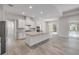 Open concept kitchen features stone countertops, white cabinetry, and stainless steel appliances at 388 Nowell Loop, Deland, FL 32724