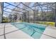 Sparkling backyard pool with a screened enclosure, overlooking the lush greenery of the yard at 388 Nowell Loop, Deland, FL 32724