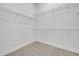 A well-organized walk-in closet with ample shelving and neutral carpeting at 388 Nowell Loop, Deland, FL 32724