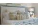 Comfortable bed featuring decorative pillows and a stylish headboard at 3881 Diving Dove Ln, Bartow, FL 33830