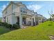 Backyard patio with string lights, comfortable seating, and green lawn at 3908 Grassland Dr, Orlando, FL 32824