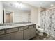 Bathroom with double vanity, granite counters, decorative mirror, and a shower with decorative curtain at 3908 Grassland Dr, Orlando, FL 32824