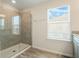 Bathroom featuring a glass-enclosed shower with light tile and a window providing natural light at 3908 Grassland Dr, Orlando, FL 32824