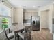 Bright kitchen area with stainless steel refrigerator and a view to the backyard at 3908 Grassland Dr, Orlando, FL 32824