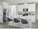 Bright kitchen features stainless steel appliances, white cabinets, and a breakfast bar with seating at 4353 Switchgrass Ln, St Cloud, FL 34772