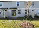 A view of the backyard of a townhome with sliding glass doors and a small patio space at 4365 Switchgrass Ln, St Cloud, FL 34772