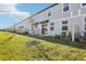 Townhome backyard featuring a well-maintained lawn, small patio and young trees along the property line at 4365 Switchgrass Ln, St Cloud, FL 34772