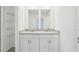 Bathroom with double vanity, granite countertop and a walk-in closet on the side at 4365 Switchgrass Ln, St Cloud, FL 34772