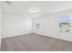 Bright bedroom featuring neutral carpet, natural light from windows, and smooth white walls at 4365 Switchgrass Ln, St Cloud, FL 34772