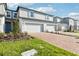 Inviting townhomes boast brick driveways, lush grass, and attached garages at 4365 Switchgrass Ln, St Cloud, FL 34772