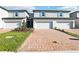 Charming townhomes featuring brick driveways, blue shutters, and well-maintained landscaping at 4365 Switchgrass Ln, St Cloud, FL 34772