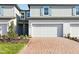 A cozy townhome with a brick driveway, garage, and tasteful landscaping at 4365 Switchgrass Ln, St Cloud, FL 34772