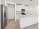 Bright kitchen with stainless appliances, island, and granite countertops at 4365 Switchgrass Ln, St Cloud, FL 34772