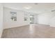 Bright living room with large windows and neutral tile flooring at 4365 Switchgrass Ln, St Cloud, FL 34772