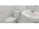 Bathroom featuring a white toilet and pedestal sink at 4369 Switchgrass Ln, St Cloud, FL 34772