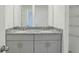Elegant bathroom with double vanity, granite counters, and ample storage space at 4369 Switchgrass Ln, St Cloud, FL 34772