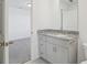 Bathroom featuring gray vanity with granite countertop and a view into bedroom at 4369 Switchgrass Ln, St Cloud, FL 34772