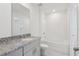 Bathroom boasts a vanity with granite counters and a shower-tub combo at 4369 Switchgrass Ln, St Cloud, FL 34772