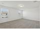 Spacious bedroom with soft carpet, two windows, and neutral color palette at 4369 Switchgrass Ln, St Cloud, FL 34772
