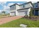 Attractive townhome featuring brick driveway, attached garage, manicured lawn, and pleasant facade at 4369 Switchgrass Ln, St Cloud, FL 34772