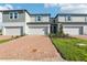 Charming townhome with brick driveway, attached garage, manicured lawn, and delightful curb appeal at 4369 Switchgrass Ln, St Cloud, FL 34772
