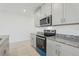 Well-equipped kitchen boasts stainless steel appliances, granite countertops, and stylish grey cabinetry at 4369 Switchgrass Ln, St Cloud, FL 34772