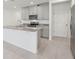 Modern kitchen with stainless steel appliances, granite countertops, and grey cabinets with ample storage at 4369 Switchgrass Ln, St Cloud, FL 34772