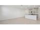 Spacious floorplan with tile flooring and recessed lighting, leading to the kitchen with an island at 4369 Switchgrass Ln, St Cloud, FL 34772