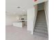 Open floor plan with tile flooring, recessed lighting, and a staircase, creating a bright and modern space at 4369 Switchgrass Ln, St Cloud, FL 34772