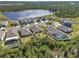 Picturesque aerial view of a residential community with a serene lake and lush greenery in the background at 512 Stowers Dr, New Smyrna Beach, FL 32168