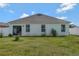 The backyard features a sliding glass door, windows, and a well-maintained lawn at 512 Stowers Dr, New Smyrna Beach, FL 32168