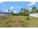 This large backyard with a white fence, has room to roam with some foliage at 512 Stowers Dr, New Smyrna Beach, FL 32168