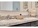 Close up of bathroom double sinks highlighting the elegant granite counters and modern fixtures at 512 Stowers Dr, New Smyrna Beach, FL 32168