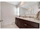 Modern bathroom featuring double sinks with granite counters and dark wood cabinets offers elegance and functionality at 512 Stowers Dr, New Smyrna Beach, FL 32168
