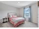 Serene bedroom with patterned drapes, soft carpet and a light color scheme provides comfort at 512 Stowers Dr, New Smyrna Beach, FL 32168