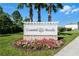 Coastal Woods community sign with flower bed and palm trees, welcoming residents and visitors alike at 512 Stowers Dr, New Smyrna Beach, FL 32168