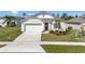 Charming single-Gathering home with a two-car garage, concrete driveway and meticulously maintained lawn at 512 Stowers Dr, New Smyrna Beach, FL 32168