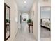 Inviting hallway with tiled flooring, neutral walls, and doorways to the living spaces at 512 Stowers Dr, New Smyrna Beach, FL 32168