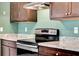 Bright kitchen with stainless steel range with exhaust hood and granite countertops at 512 Stowers Dr, New Smyrna Beach, FL 32168