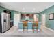 Modern kitchen featuring a stainless steel refrigerator, ample cabinets, and granite countertops at 512 Stowers Dr, New Smyrna Beach, FL 32168