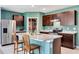 Inviting kitchen featuring an island with granite countertops, stainless steel appliances, and wooden cabinetry at 512 Stowers Dr, New Smyrna Beach, FL 32168