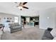 Bright living room flowing into an open kitchen with stainless steel appliances and a breakfast bar at 512 Stowers Dr, New Smyrna Beach, FL 32168