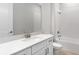 Clean bathroom featuring a white vanity with sleek fixtures and a bathtub with tile surround at 5641 Nevis Ter, Kissimmee, FL 34758