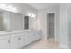 Contemporary bathroom featuring a dual sink vanity, large mirrors, and modern lighting at 5641 Nevis Ter, Kissimmee, FL 34758