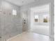 Luxurious walk-in shower featuring tile walls, dual shower heads, and glass enclosure at 5641 Nevis Ter, Kissimmee, FL 34758
