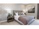Comfortable bedroom with a decorative headboard, soft lighting, and neutral decor at 5641 Nevis Ter, Kissimmee, FL 34758