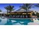 Evening shot of the beautiful community pool and Bahama Bar, perfect for relaxed evenings and social gatherings at 5641 Nevis Ter, Kissimmee, FL 34758
