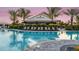 Bahama Bar behind a beautiful community pool and lounge chairs offering a luxurious resort-style experience at 5641 Nevis Ter, Kissimmee, FL 34758