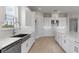 Bright kitchen with white cabinets, stainless steel appliances, and tile backsplash at 5641 Nevis Ter, Kissimmee, FL 34758
