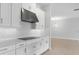 Modern white kitchen showcasing stainless steel appliances, sleek countertops, and minimalist hardware at 5641 Nevis Ter, Kissimmee, FL 34758